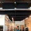 PremiumBeat Open Office Plan - The black fabric wrapped acoustical baffles are easily hung from the existing truss ceiling.